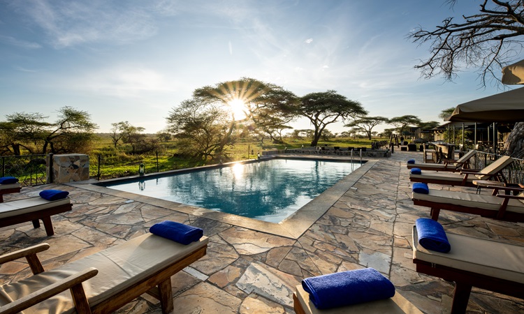 Sametu Camp in the Serengeti with a swimming pool overlooking the breathtaking sunrise, offering a peaceful retreat during a Five-Day Serengeti Safari