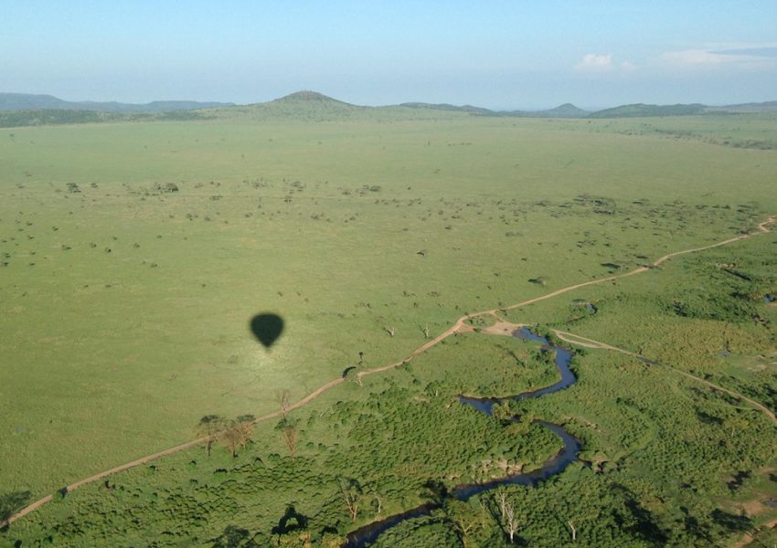 Hot air balloon flying over Ndutu during a 5-Day Fly-in Southern Serengeti Safari, offering panoramic views of wildlife and landscapes.