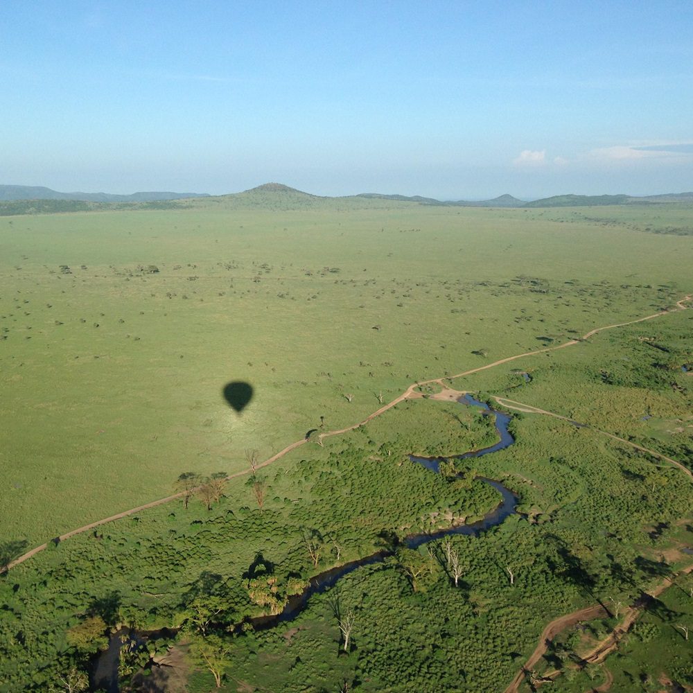 Hot air balloon flying over Ndutu during a 5-Day Fly-in Southern Serengeti Safari, offering panoramic views of wildlife and landscapes.
