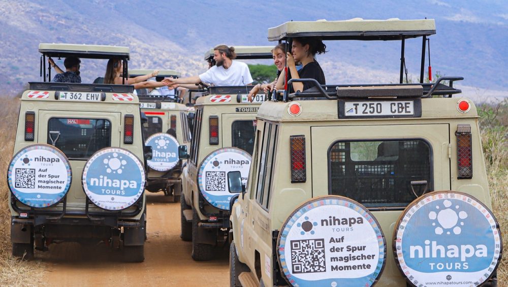 Visitors enjoying a wildlife safari inside a Nihapa Tours vehicle in Tanzania, showing what an African safari costs