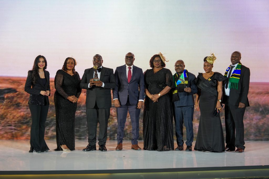 Tanzania delegation holding the World Travel Awards 2025 trophy on stage during the Bahrain gala