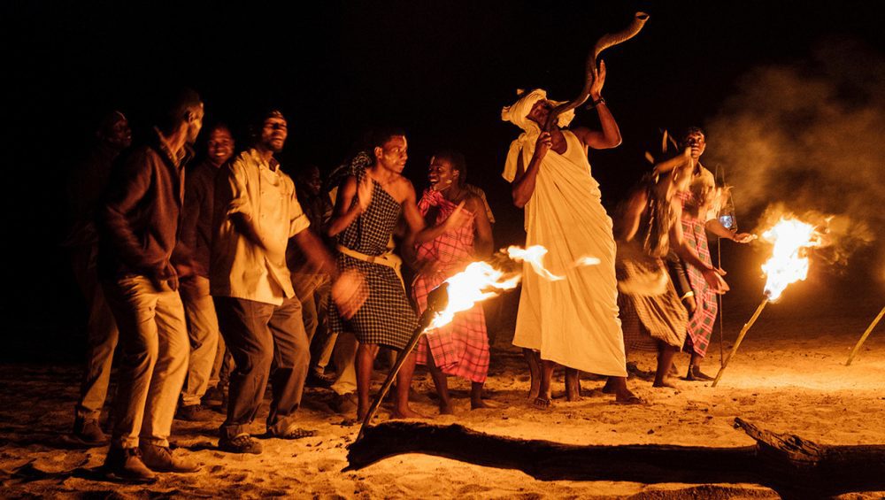 Cultural dance beside a fire during a 10-Day Exclusive Tanzania Safari