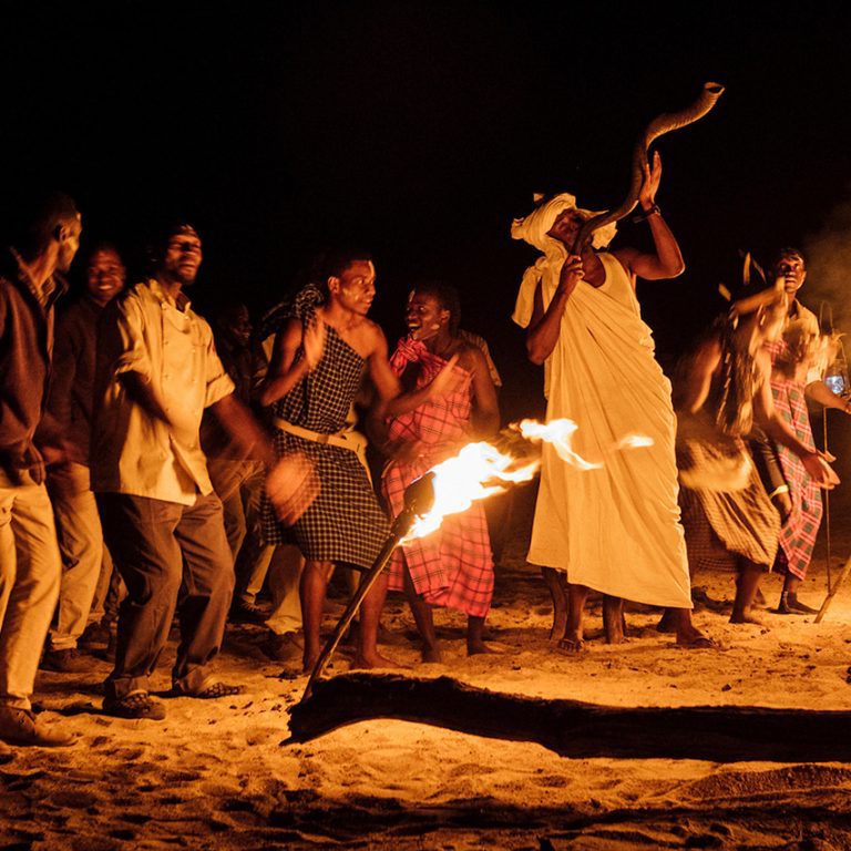 Cultural dance beside a fire during a 10-Day Exclusive Tanzania Safari