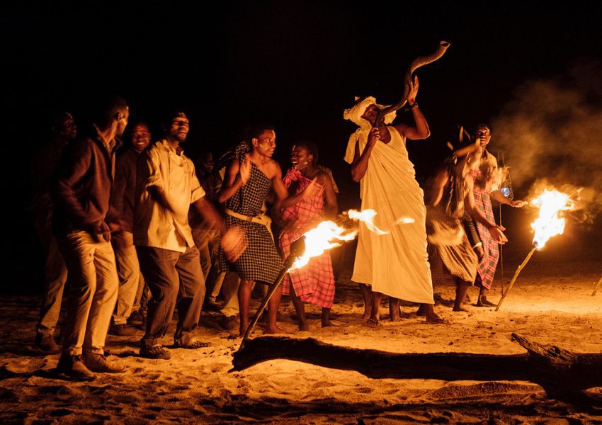 Cultural dance beside a fire during a 10-Day Exclusive Tanzania Safari