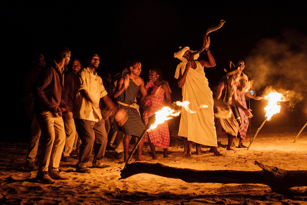 Cultural dance beside a fire during a 10-Day Exclusive Tanzania Safari