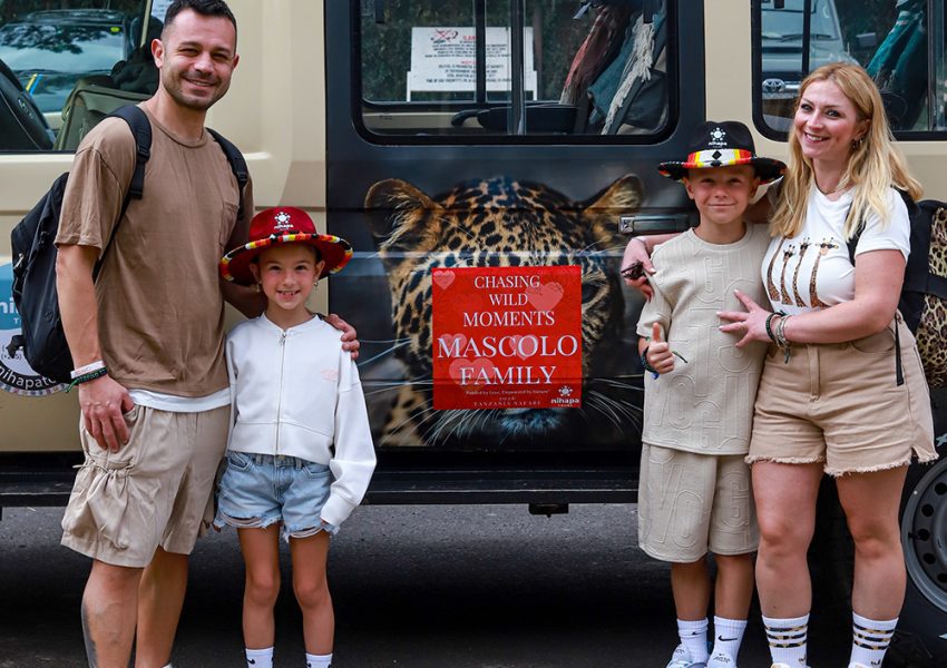 Guests posing with a Nihapa Tours safari vehicle in Arusha, ready to start their 3-Day Fly-In Central Serengeti Safari From Zanzibar