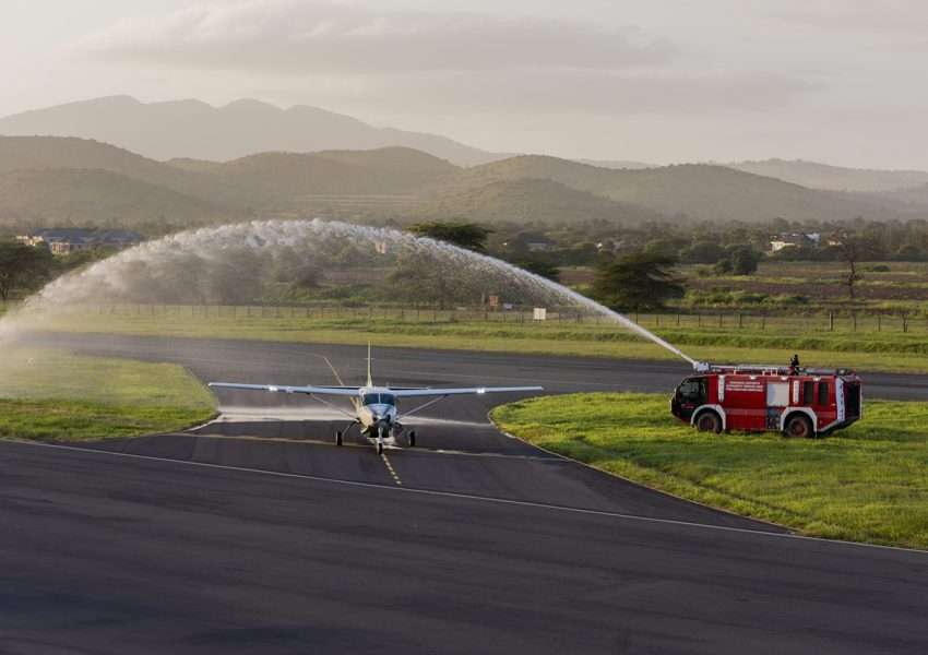 Miracle Air aircraft being welcomed with water at Arusha Airport, a trusted airline in Arusha for safari travelers.