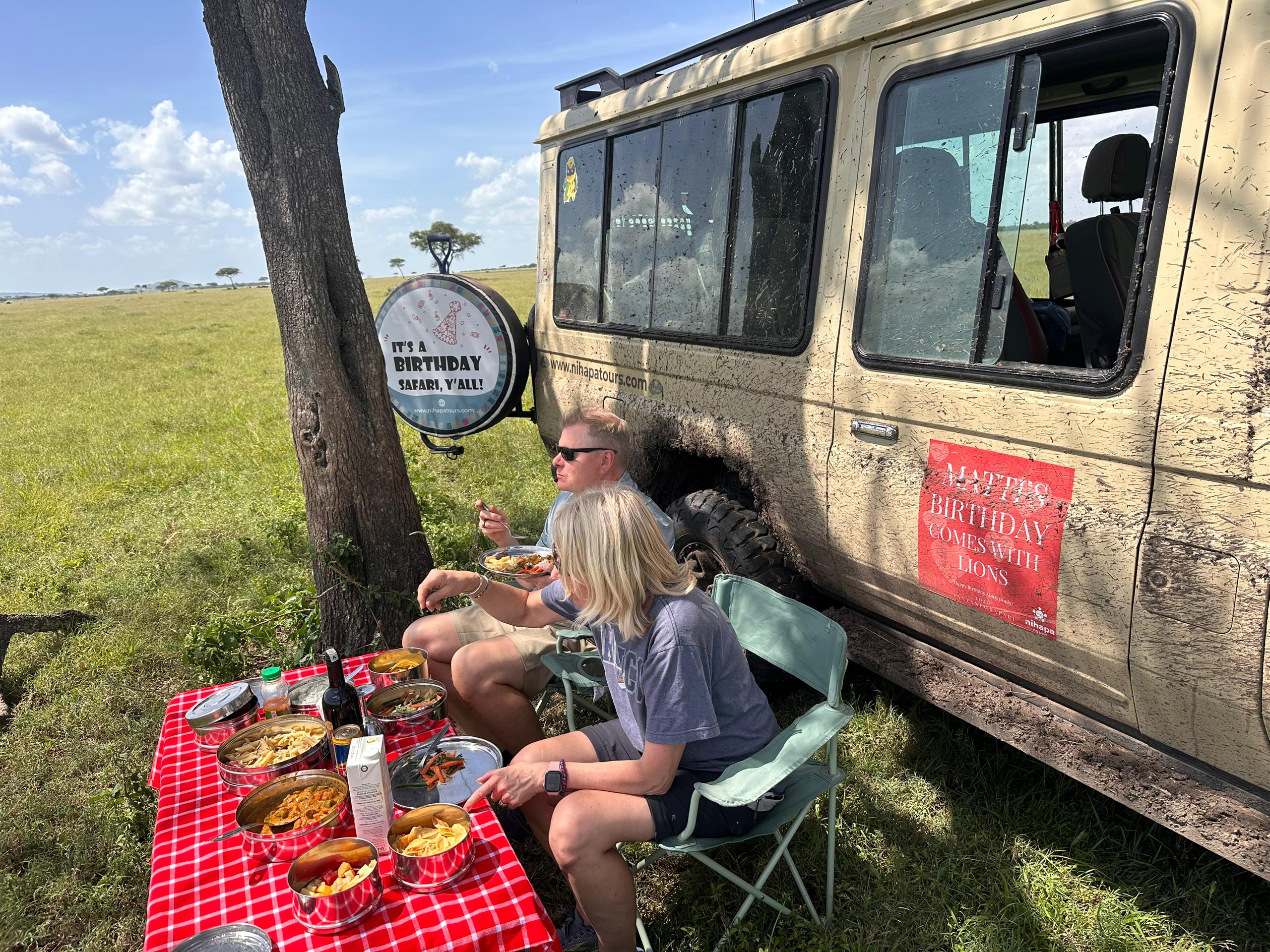Travellers enjoying a safari picnic lunch in Tanzania